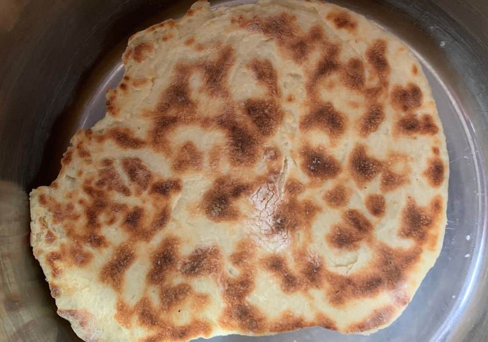 piece of naan bread cooking in the Instant Pot