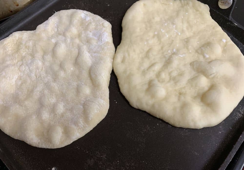 naan bread cooking on a griddle