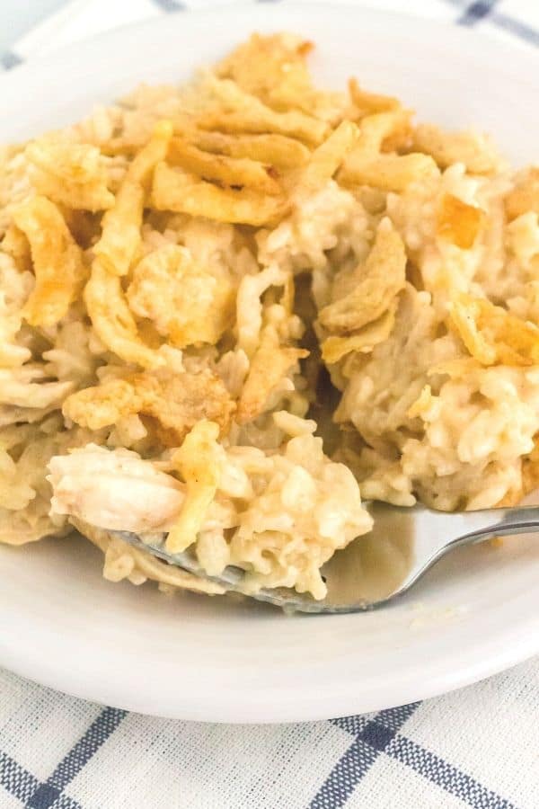 easy chicken and rice with onion soup mix cooked in the Instant Pot, served on a white plate with a fork on the plate