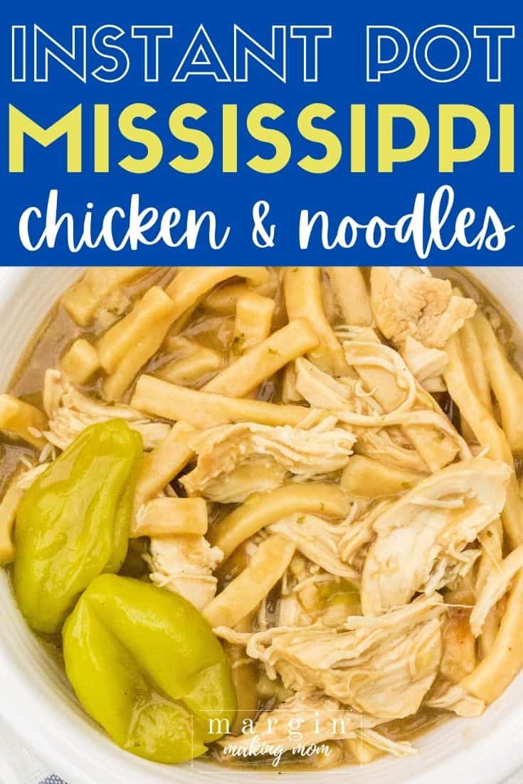 A bowl of Mississippi chicken and noodles cooked in the Instant Pot, with two pepperoncini garnishes,