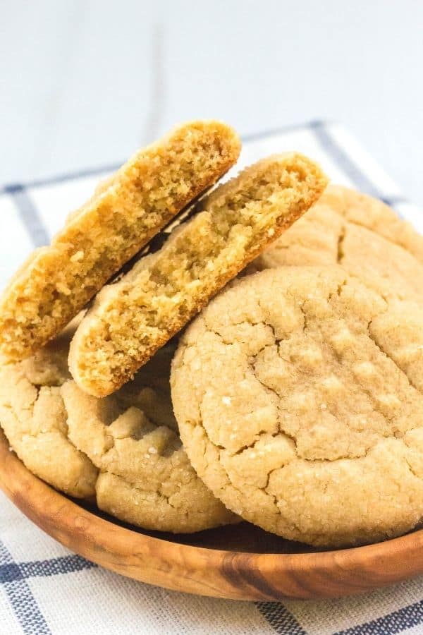 several peanut butter cookies made with pancake mix stacked on a small wooden plate