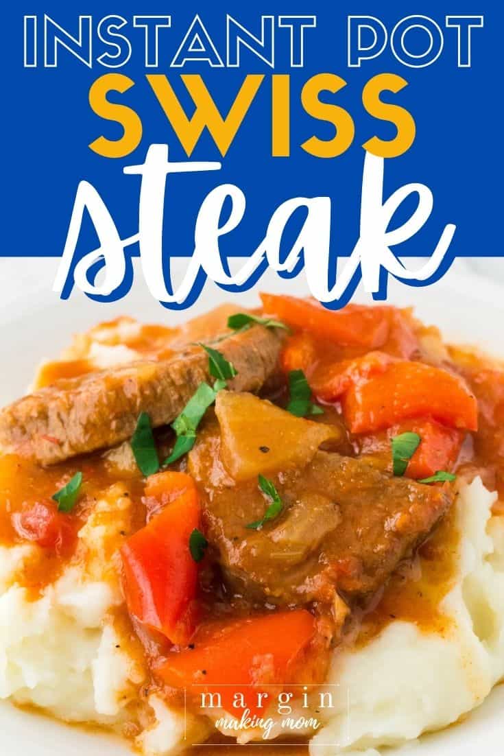 Instant Pot Swiss steak and peppers served over a bed of mashed potatoes on a white plate