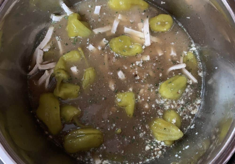 ingredients for Mississippi chicken and noodles in the insert pot of the Instant Pot, ready to be cooked