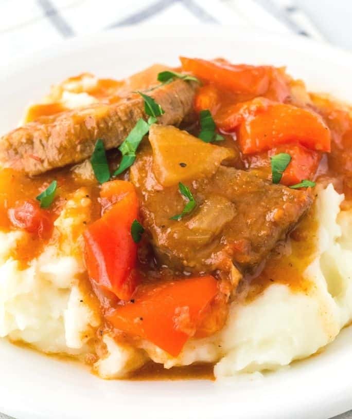 Instant Pot Swiss steak and peppers over a bed of mashed potatoes