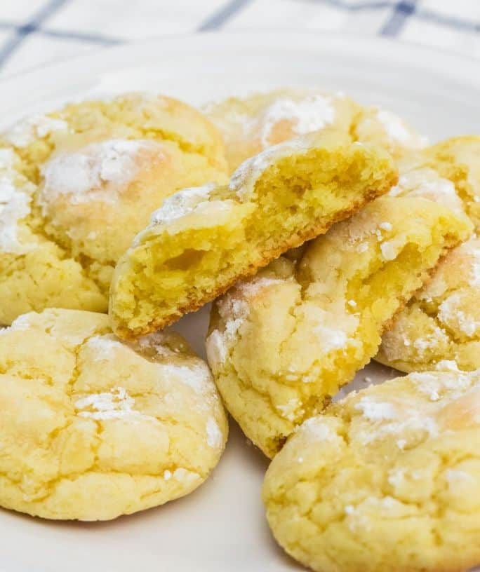 several lemon pudding crinkle cookies on a white plate