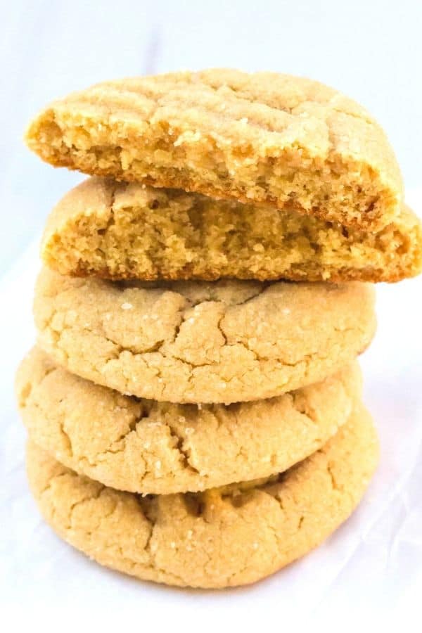 a stack of peanut butter cookies made with pancake mix, with the top cookie broken in half