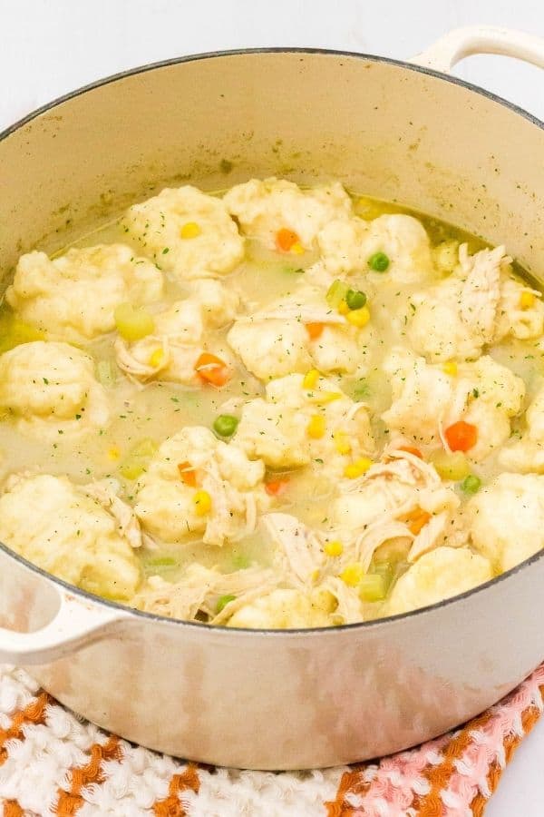 Le Creuset Dutch oven filled with homemade chicken and dumplings made with Jiffy Baking Mix