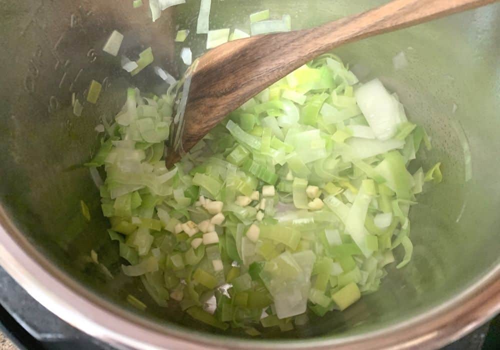 leeks, onions, and garlic in the Instant Pot for potato and leek soup