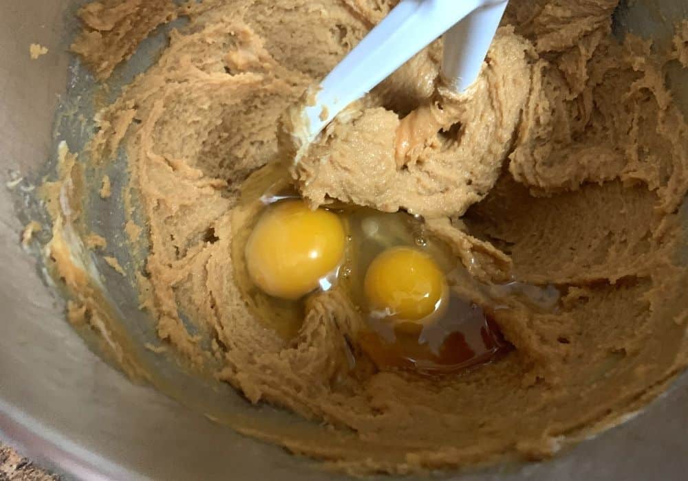Batter ingredients in a mixing bowl for making peanut butter cookies with pancake mix