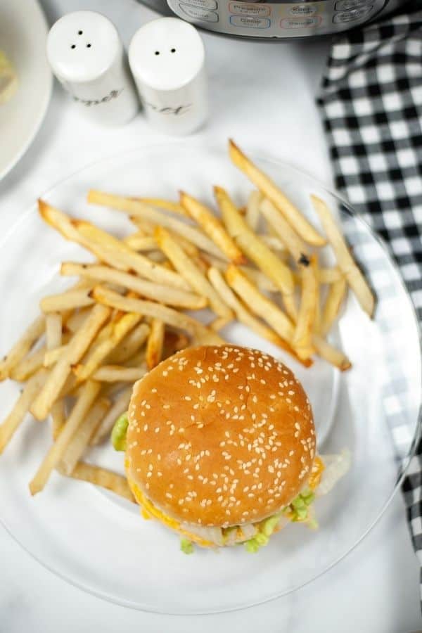 overhead view of an Instant Pot burger with fries on a clear glass plate