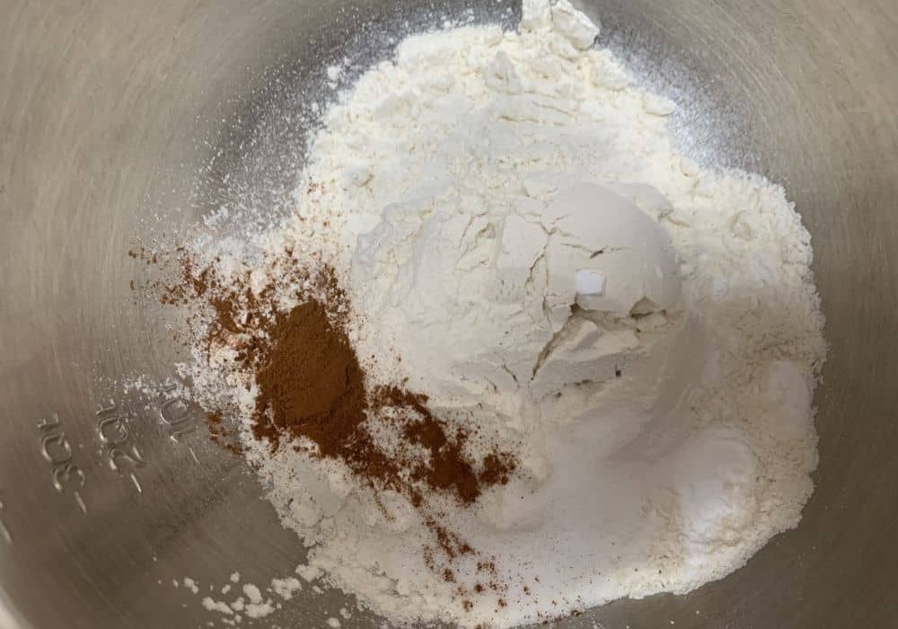 Dry ingredients for preacher cake combined in a metal mixing bowl