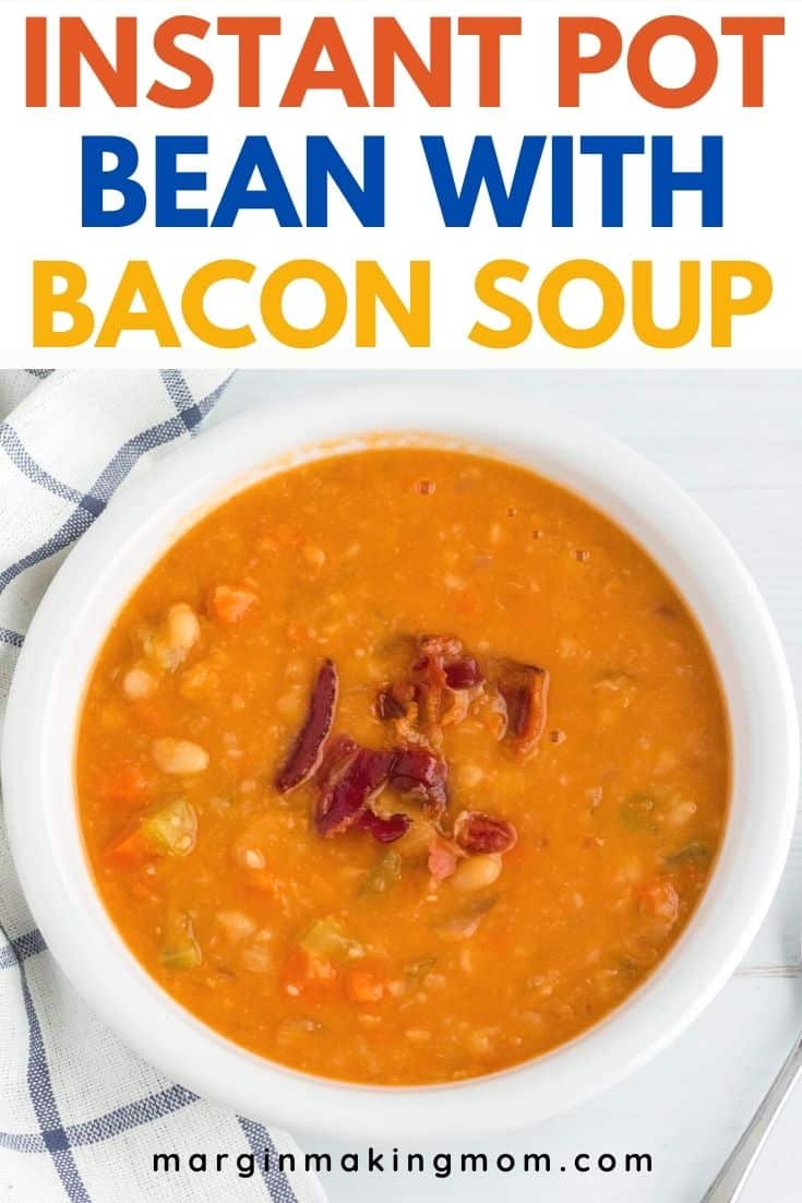 white bowl filled with Instant Pot bean with bacon soup and garnished with bacon crumbles, nestled against a blue and white checkered napkin.