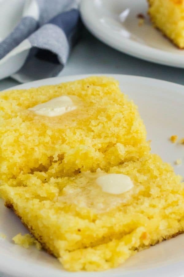 Moist and tender Jiffy cornbread with pats of butter melting on top.