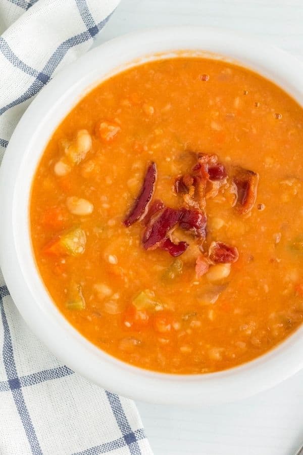 a bowl of navy bean and bacon soup that was cooked in the pressure cooker