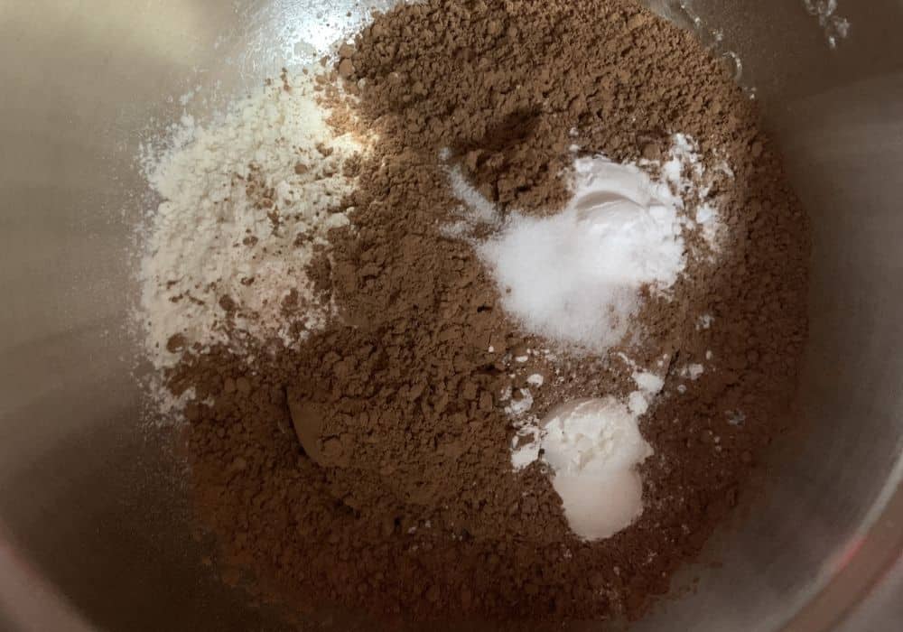 Dry ingredients in a silver mixing bowl, ready to be whisked together and added gradually to the wet ingredients.