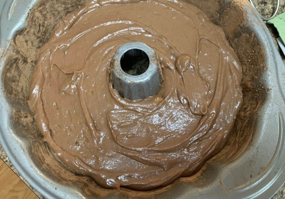 finished batter for chocolate sour cream cake, poured into a prepared bundt pan for baking.