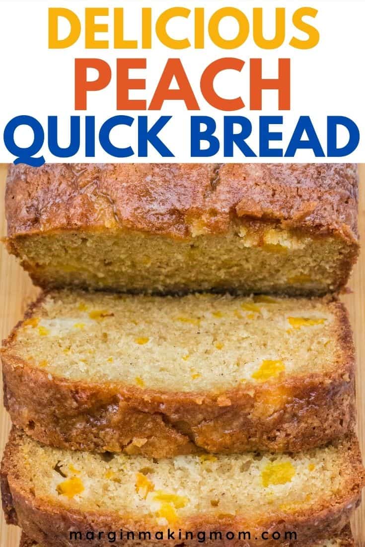 a sliced loaf of peach bread on a wooden cutting board, showing the moist interior dotted with pieces of peaches.