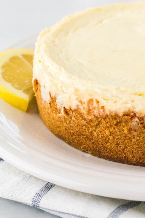 Whole lemon cheesecake cooked in the pressure cooker, served on a white plate