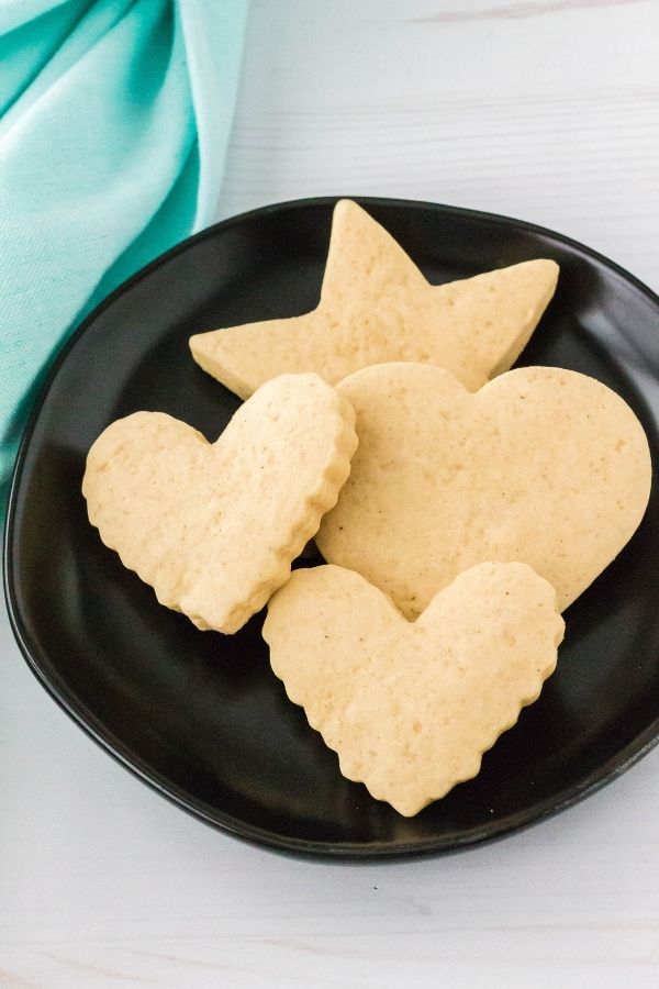 Italian sour cream cutout cookies on a black plate