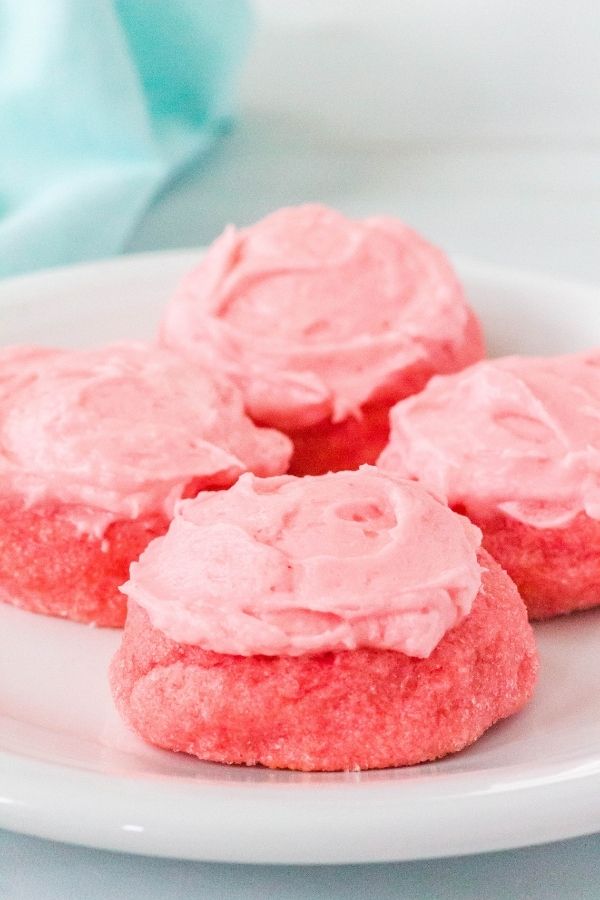 sugar cookies made with strawberry Jello on a white plate