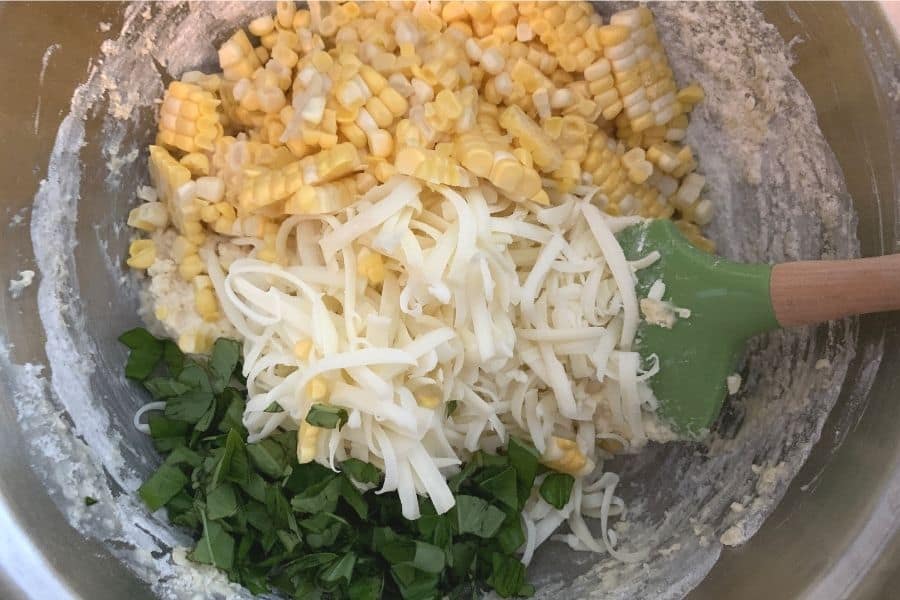 fresh corn, shredded mozzarella, and fresh basil added to the batter for making muffins
