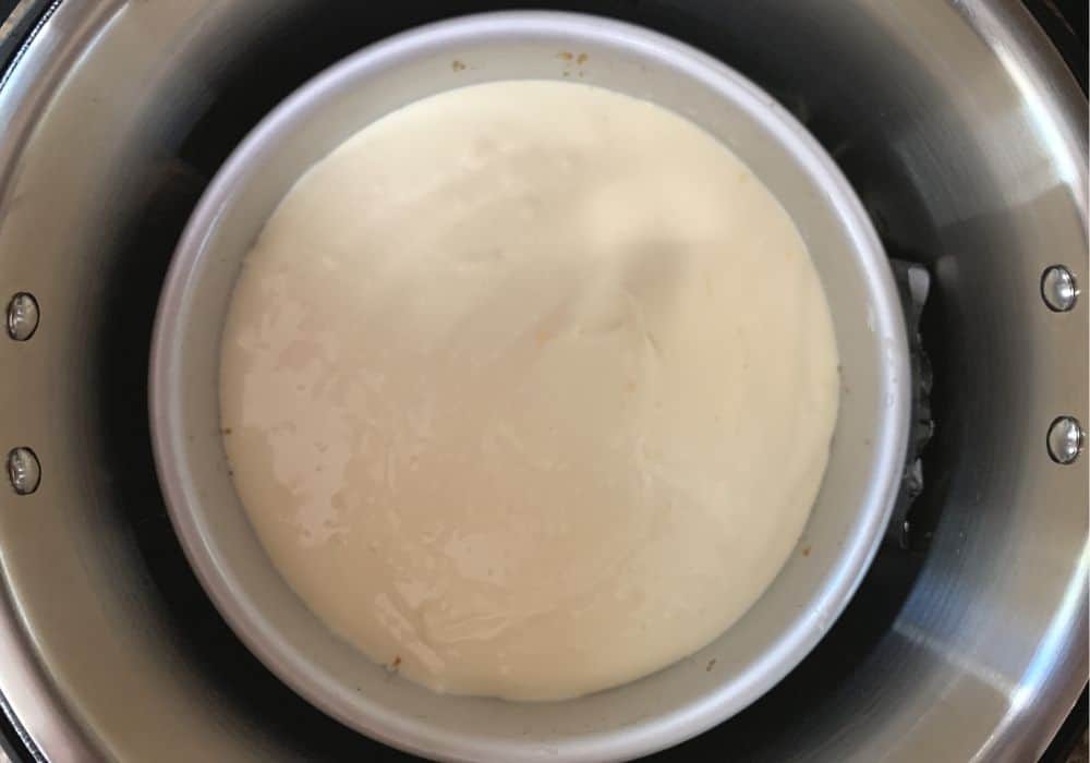 cheesecake pan lowered into the insert pot of the Instant Pot