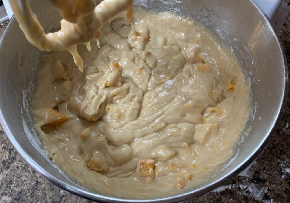 peach bread batter in the bowl of a stand mixer