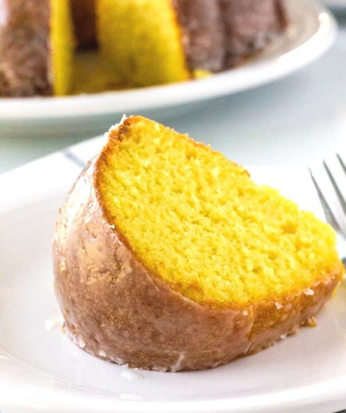 slice of old-fashioned apricot nectar cake on a white plate