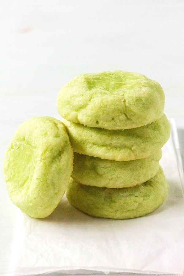 a stack of lime jello sugar cookies on a piece of white parchment paper