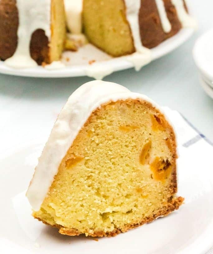 slice of peach sour cream pound cake on a white plate