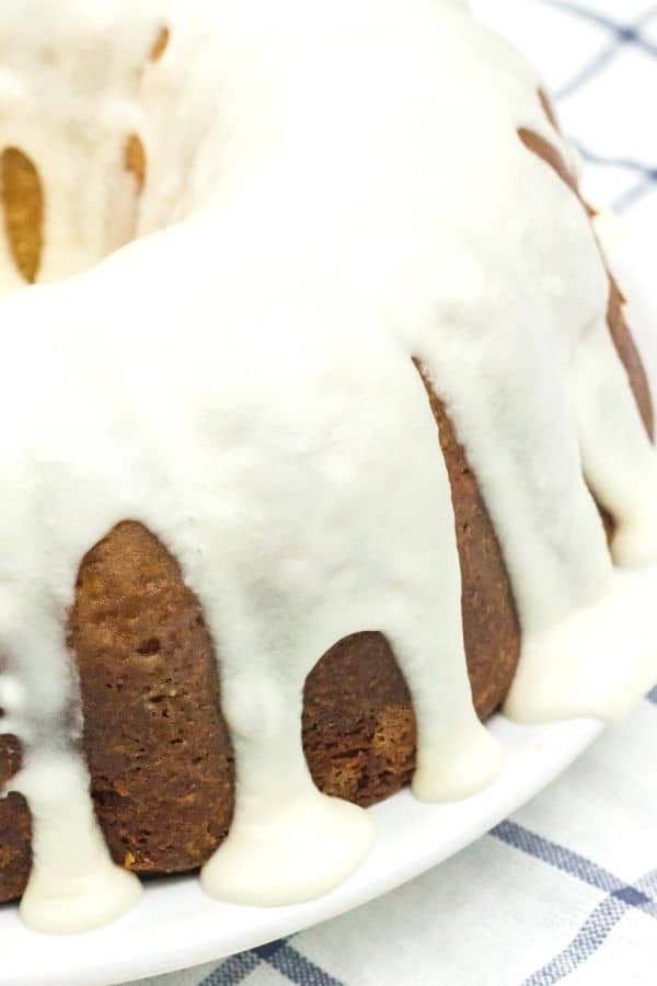 close-up view of vanilla glaze drizzled over a homemade peach sour cream pound cake