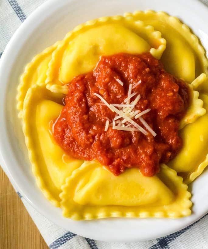 white plate topped with a serving of frozen cheese ravioli cooked in the Instant Pot