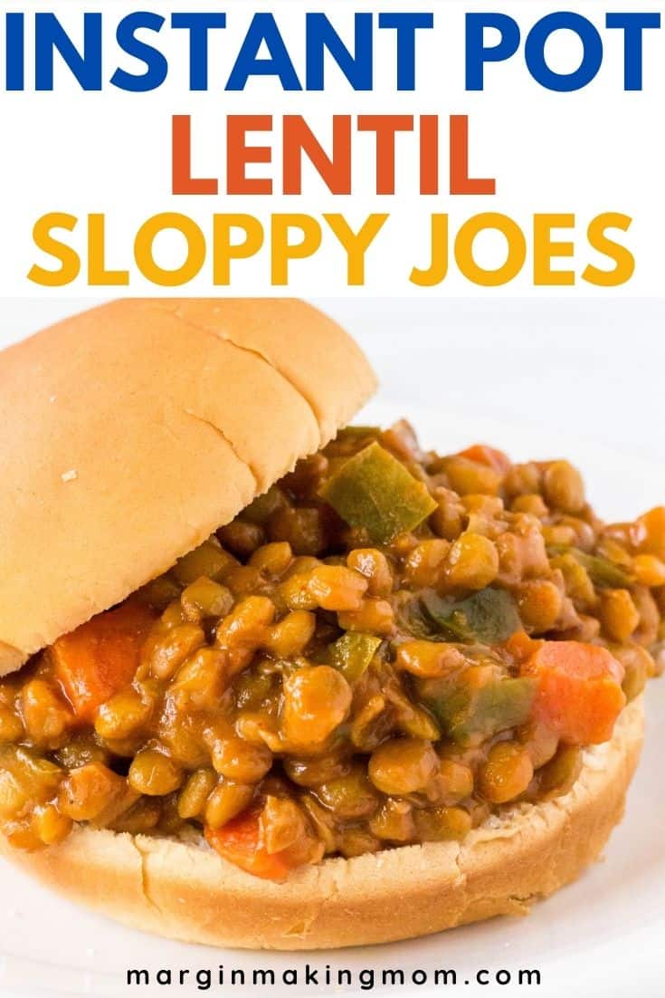 side view of an Instant Pot lentil Sloppy Joe sandwich, with the top bun offset to the side, displaying more of the filling of lentils, sauce, carrots, and peppers.