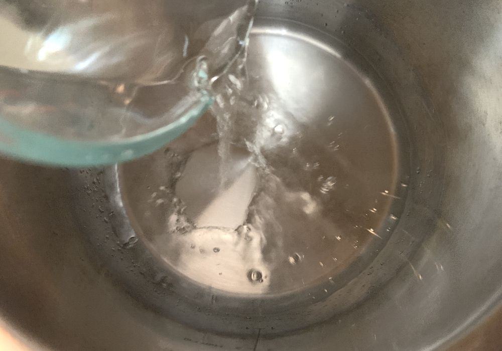 water being poured into the insert pot of the Instant Pot for cooking tortellini