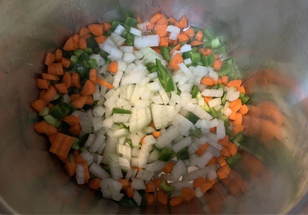 onions, carrots, and bell peppers added to olive oil in the Instant Pot for sauteeing for lentil sloppy joes.