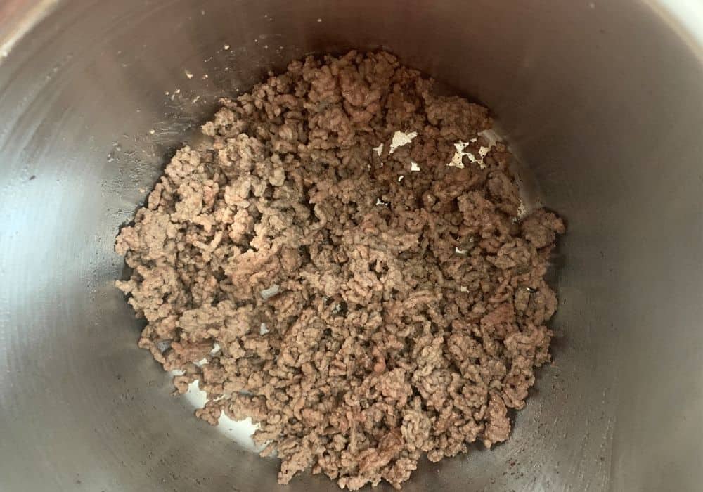 ground beef browned in the insert pot of the Instant Pot for ravioli lasagna