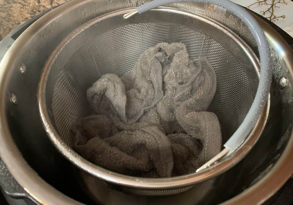 gray dish cloths that had been stinky have just finished their steam cycle in the Instant Pot and are ready to be removed to dry.