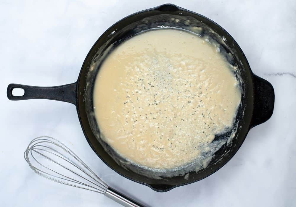 a roux being made in a cast iron skillet