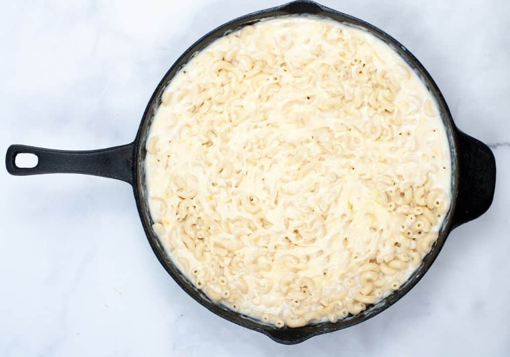 remaining ingredients added to the cast iron skillet for baking the mac n cheese