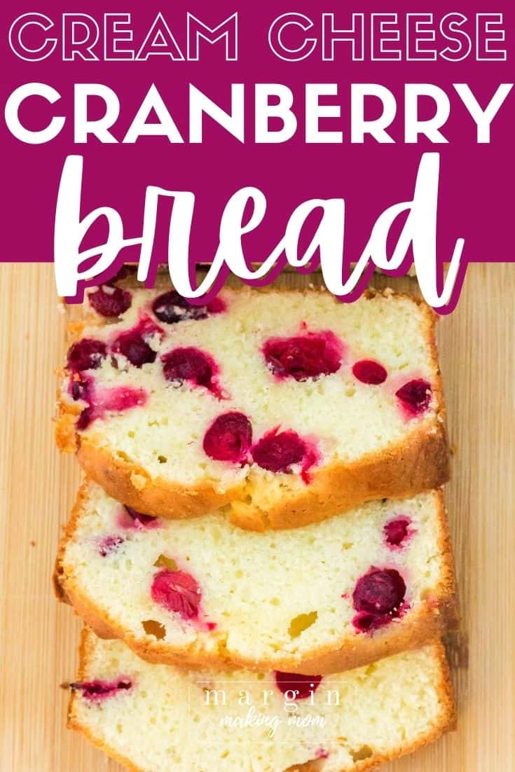 Sliced loaf of cream cheese cranberry bread on a cutting board
