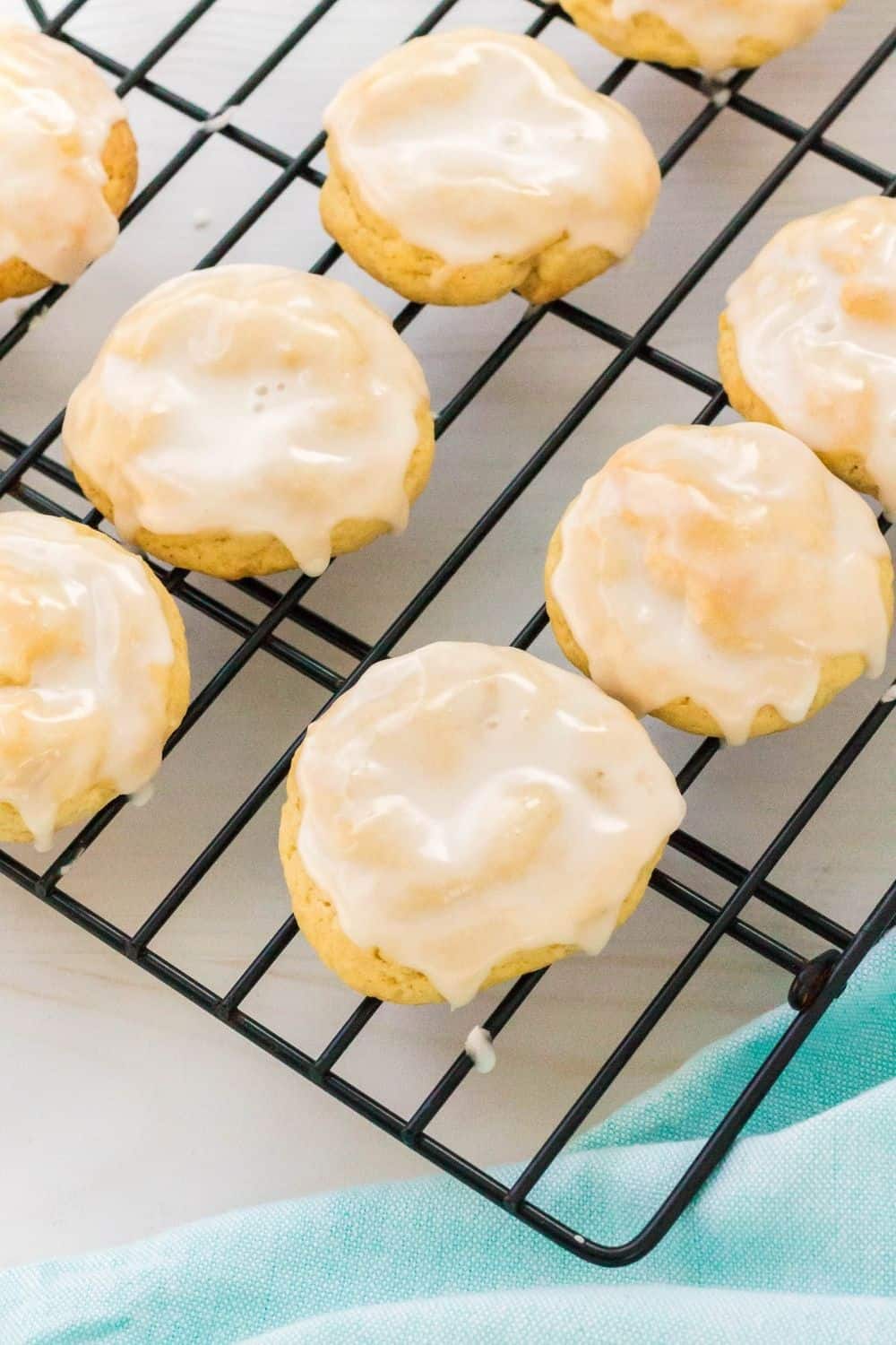 several pineapple cookies topped with satiny icing, on a cooling rack