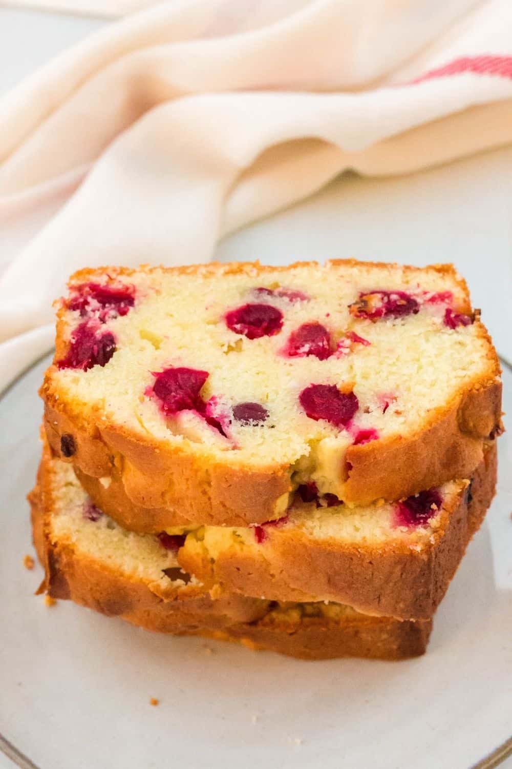 slices of cranberry bread stacked on a plate