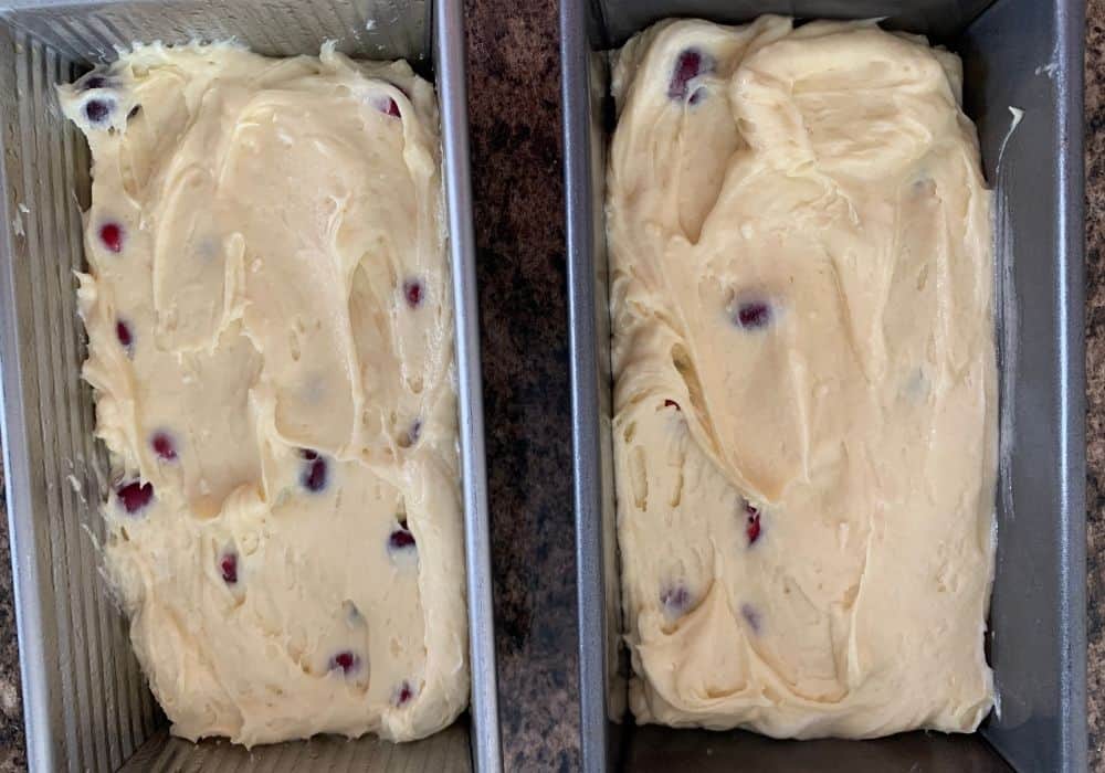 fresh cranberry bread batter in two loaf pans