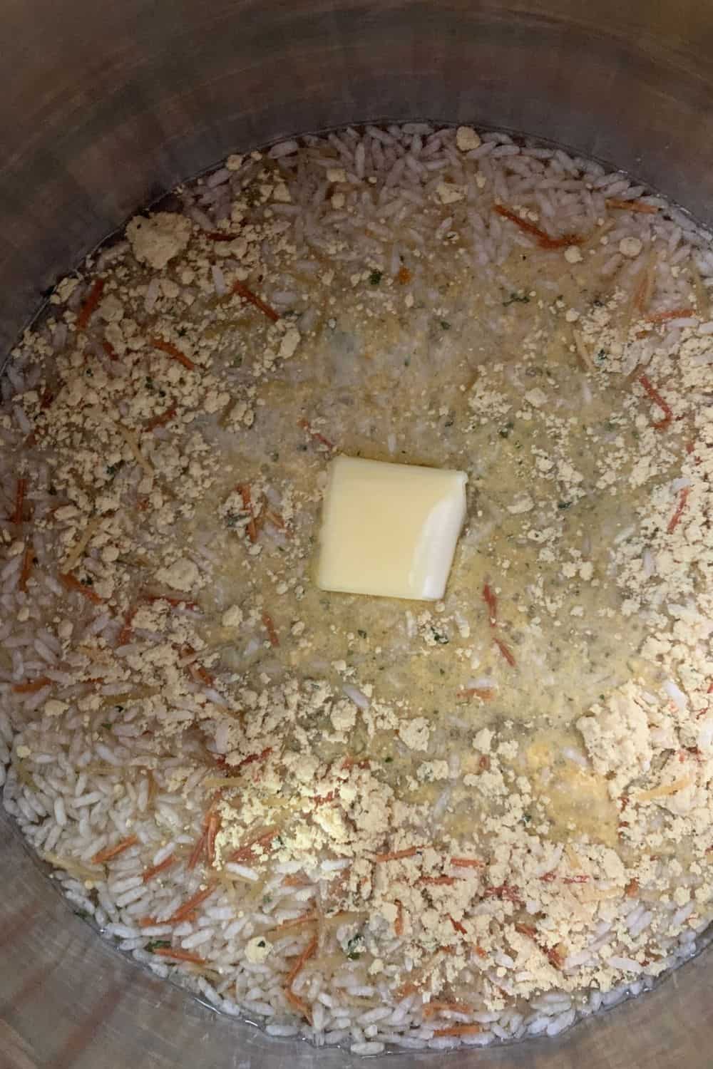 Knorr Rice Sides in the Instant Pot with water and butter, ready to be pressure cooked