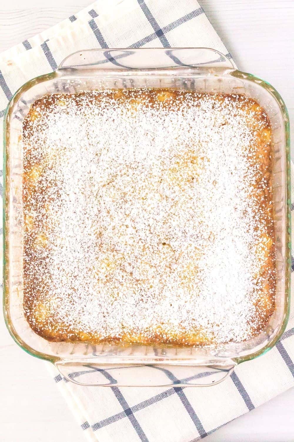 pineapple cake freshly baked, still in the pan and dusted with powdered sugar