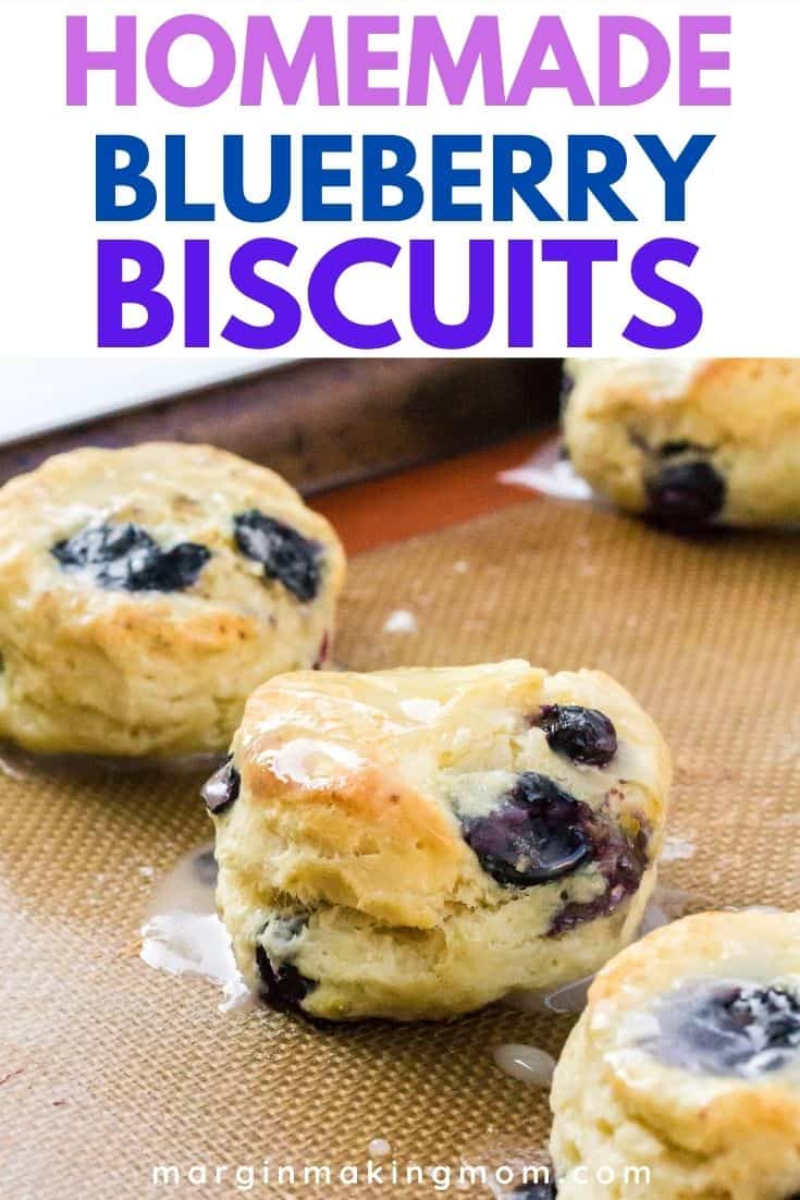 several blueberry biscuits on a silicone mat-lined baking sheet