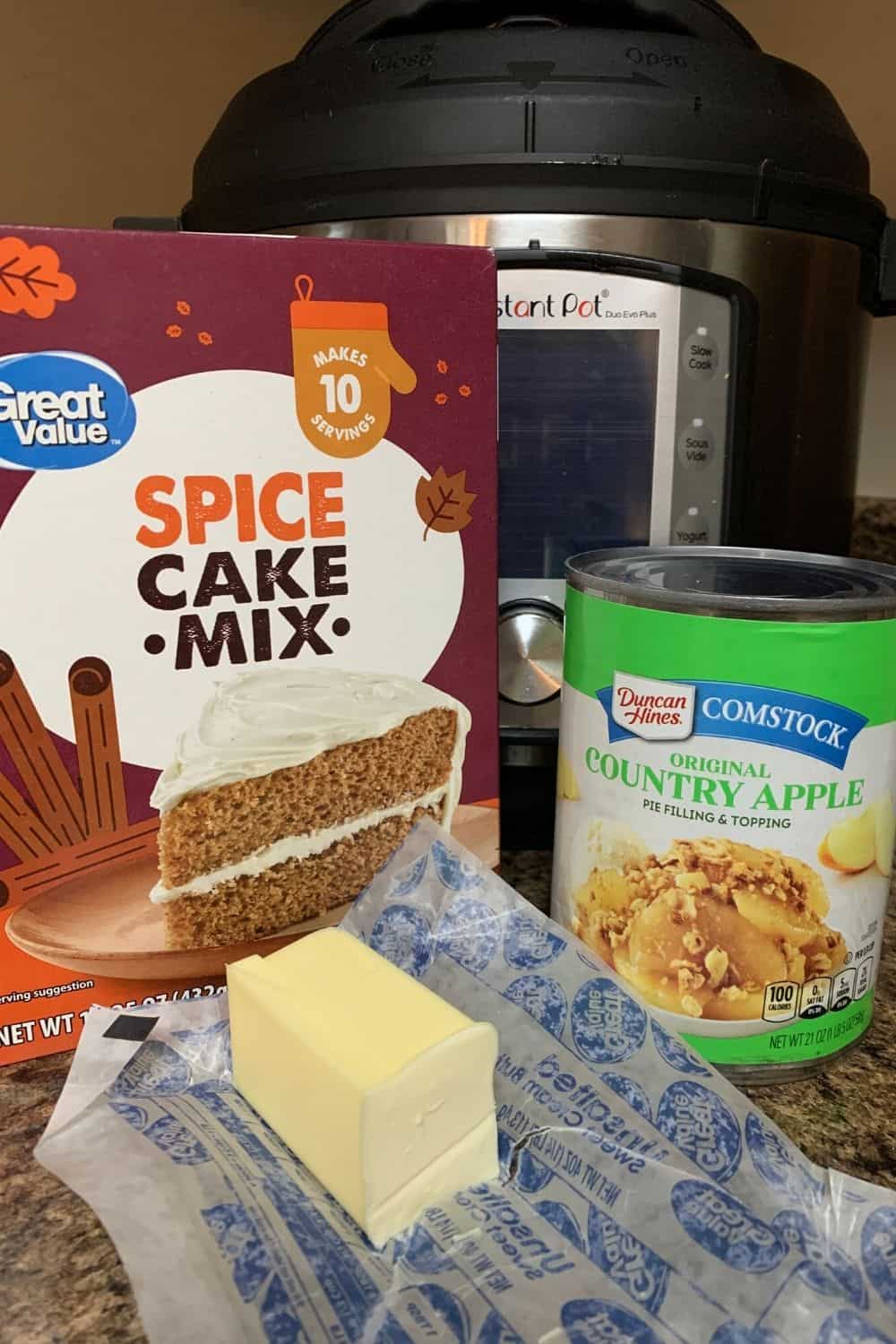 spice cake mix, butter, and apple pie filling positioned in front of the Instant Pot