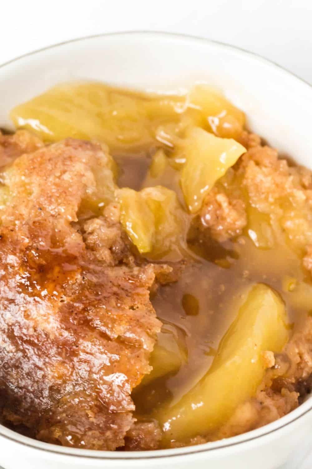 close-up view of Instant Pot apple cobbler dump cake in a white bowl