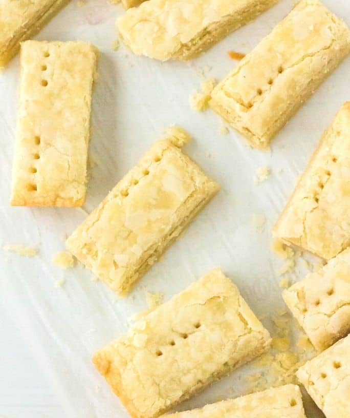 several Scottish shortbread cookies on a piece of parchment paper