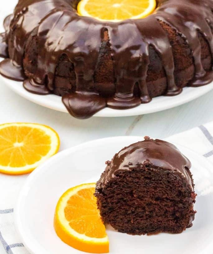 slice of chocolate orange cake in front of the rest of the cake
